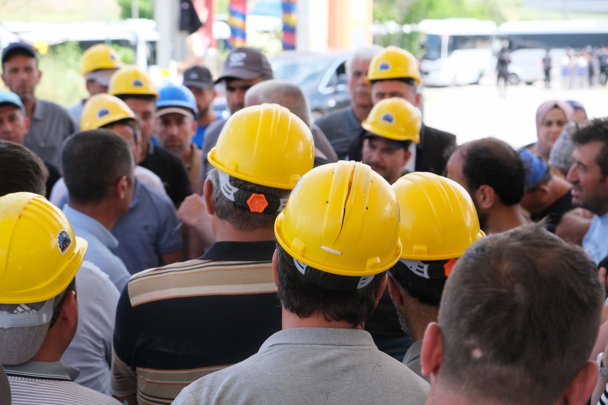 Group of construction workers in safety helmets on site