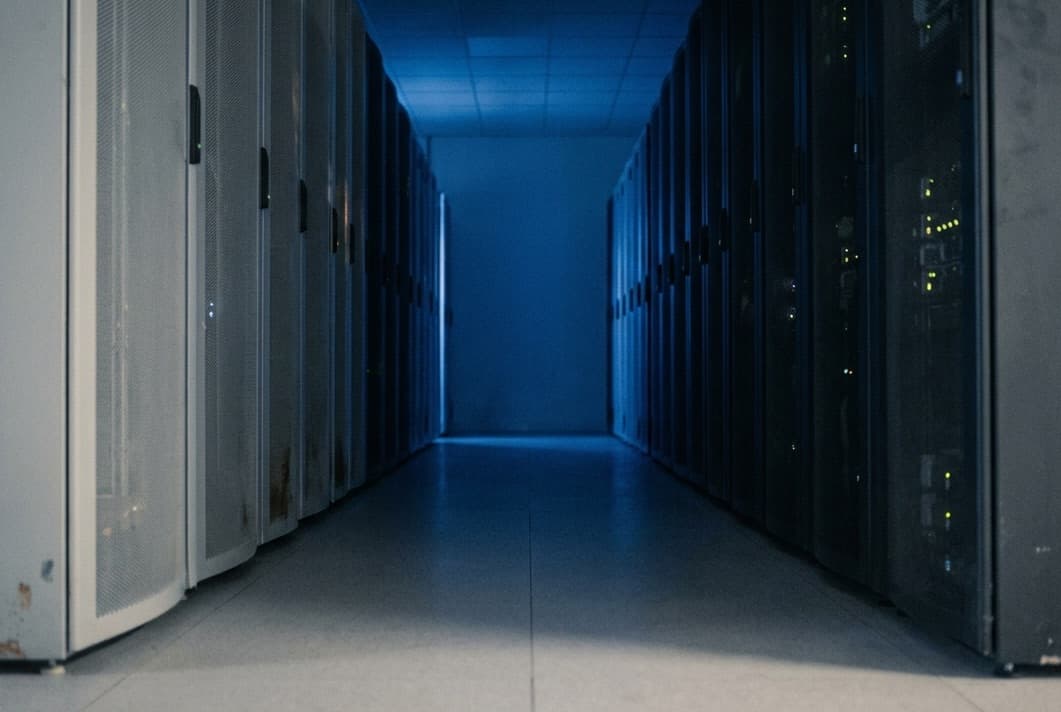 Engineer with a tablet in a data centre aisle