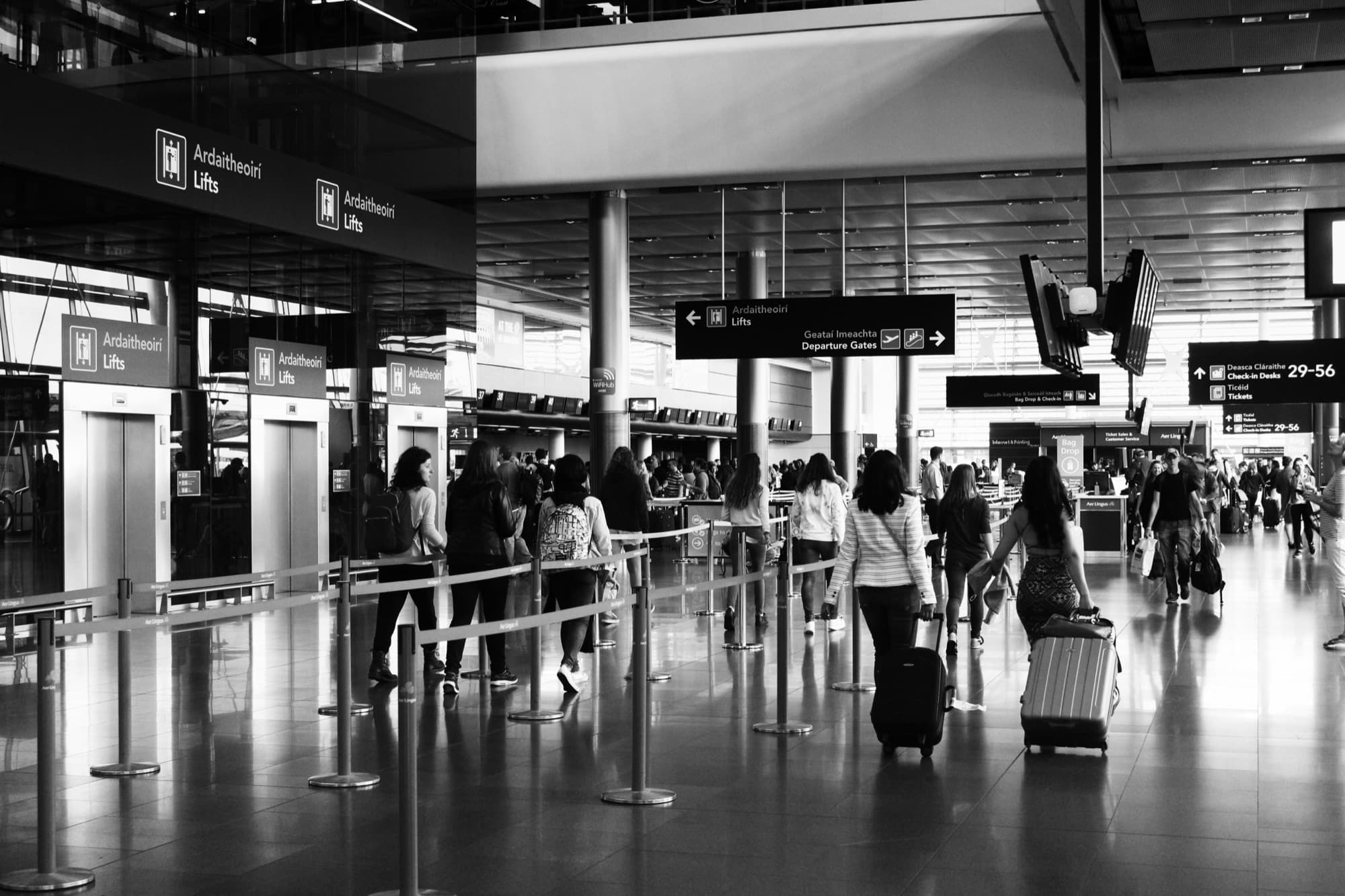 Travellers with luggage in an airport departure terminal